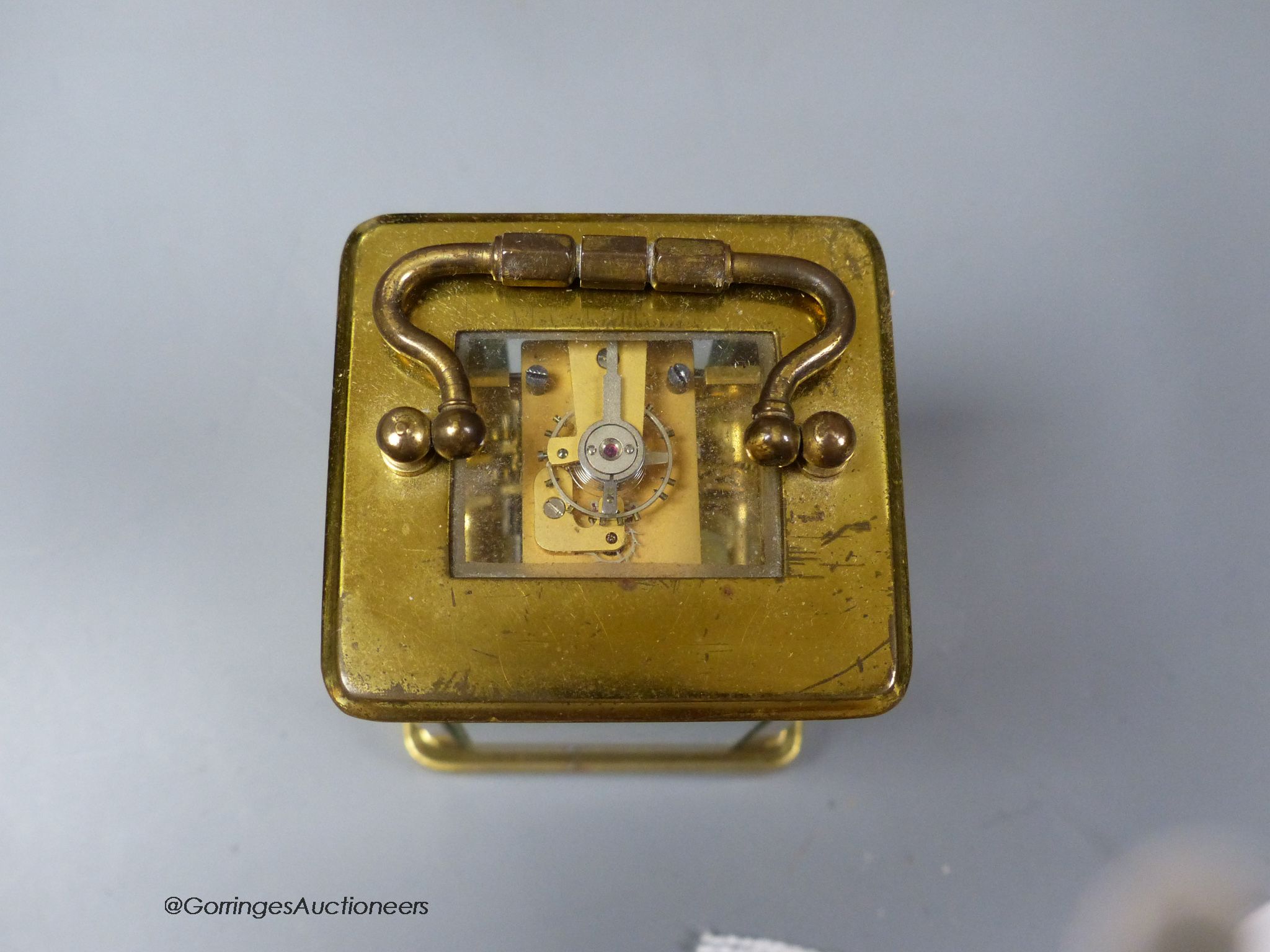 A brass cased carriage timepiece, 7.5cm, in a leather carrying case